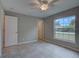 Bedroom featuring tile floors, a ceiling fan, and a large window at 25 Sabot Ct, Placida, FL 33946