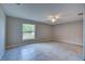 Bright bedroom with a ceiling fan and a large window offering a view of the outdoors at 25 Sabot Ct, Placida, FL 33946