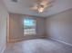 Bedroom features a ceiling fan, and a large window with a view at 25 Sabot Ct, Placida, FL 33946