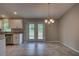 Bright dining area with double doors leading to the backyard and a stylish chandelier at 25 Sabot Ct, Placida, FL 33946