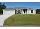 Charming single-story home with a well-manicured lawn and attached two-car garage at 25 Sabot Ct, Placida, FL 33946