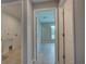 Hallway view featuring tile floors, white trim, and neutral paint at 25 Sabot Ct, Placida, FL 33946