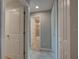Hallway view showcasing neutral wall colors, tile flooring, and multiple doorways to rooms at 25 Sabot Ct, Placida, FL 33946
