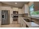Well-equipped kitchen featuring stainless steel appliances, granite countertops, and bright lighting at 25 Sabot Ct, Placida, FL 33946