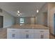 Spacious kitchen island with granite countertop and white cabinets in a bright, open floor plan at 25 Sabot Ct, Placida, FL 33946