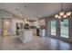 Bright kitchen features white cabinets, stainless appliances, granite counters, and backyard access at 25 Sabot Ct, Placida, FL 33946