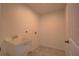 Laundry room featuring a utility sink, tile flooring, and neutral wall color at 25 Sabot Ct, Placida, FL 33946