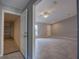 Open-concept living room showcasing neutral gray walls, tile floors, and a ceiling fan at 25 Sabot Ct, Placida, FL 33946