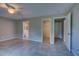 Main bedroom featuring tile floors, a ceiling fan, and access to a walk-in closet and ensuite bathroom at 25 Sabot Ct, Placida, FL 33946