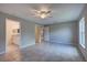 Spacious main bedroom with a ceiling fan and multiple doorways leading to the bathroom and closets at 25 Sabot Ct, Placida, FL 33946