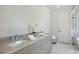 Elegant bathroom featuring a double vanity with marble countertop and white cabinets at 2596 Floyd St, Sarasota, FL 34239
