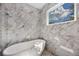 Bathroom with soaking tub and marble surround at 2596 Floyd St, Sarasota, FL 34239
