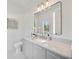 Modern bathroom with gray vanity, white marble countertop, and a large mirror at 2596 Floyd St, Sarasota, FL 34239