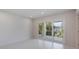 Bright bedroom featuring recessed lighting and sliding doors to a balcony overlooking lush greenery at 2596 Floyd St, Sarasota, FL 34239