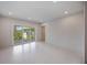 Bright bedroom featuring recessed lighting and sliding doors to a balcony overlooking lush trees at 2596 Floyd St, Sarasota, FL 34239