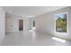 Bright bedroom featuring large windows, neutral walls, and tiled floors, providing a spacious and airy feel at 2596 Floyd St, Sarasota, FL 34239