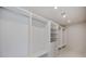 Spacious walk-in closet featuring custom shelving and drawers, providing ample storage solutions at 2596 Floyd St, Sarasota, FL 34239