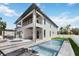 Back exterior of home with covered patios, a refreshing pool, and landscaped backyard at 2596 Floyd St, Sarasota, FL 34239