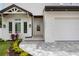 Charming home exterior featuring a well-manicured lawn, walkway, and an inviting entrance with large windows at 2596 Floyd St, Sarasota, FL 34239
