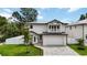 Charming two-story home with a well-manicured lawn, gray brick drive and white exterior at 2596 Floyd St, Sarasota, FL 34239