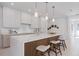 This modern kitchen features a large island, beautiful countertops, and stylish pendant lighting at 2596 Floyd St, Sarasota, FL 34239