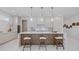 Modern kitchen offers an island with seating, stainless appliances, and lots of natural light at 2596 Floyd St, Sarasota, FL 34239