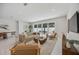 Bright living room features a beige sofa, modern furnishings, and sliding glass doors to outdoor space at 2596 Floyd St, Sarasota, FL 34239