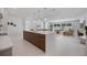 Open concept living space with kitchen, dining, and living room flowing seamlessly with lots of natural light at 2596 Floyd St, Sarasota, FL 34239