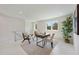 Bright loft area with modern furniture, a desk, neutral rug, and large windows at 2596 Floyd St, Sarasota, FL 34239