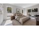 Sunlit main bedroom features neutral decor, modern furnishings, and access to a private outdoor space at 2596 Floyd St, Sarasota, FL 34239