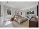 Bright main bedroom boasts neutral colors, modern furnishings, and private outdoor access at 2596 Floyd St, Sarasota, FL 34239