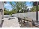 Cozy outdoor patio with a modern dining set, lush landscaping, and access to a refreshing pool at 2596 Floyd St, Sarasota, FL 34239