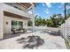 Spacious outdoor patio featuring a modern pool with a fountain, outdoor seating and a ceiling fan at 2596 Floyd St, Sarasota, FL 34239