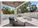 Covered patio with comfortable seating, overlooks the refreshing pool and modern, landscaped backyard at 2596 Floyd St, Sarasota, FL 34239