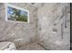 This shower has marble surround and a window to let in the light at 2596 Floyd St, Sarasota, FL 34239