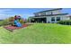 Spacious backyard featuring green grass and outdoor playset, perfect for recreation and fun at 2806 Starwood Ct, Lakewood Ranch, FL 34211