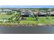Aerial view of a backyard with pond, playground, and solar panels on roof at 2806 Starwood Ct, Lakewood Ranch, FL 34211