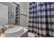 Modern bathroom features a vessel sink, gold faucet, and striped shower curtain at 2806 Starwood Ct, Lakewood Ranch, FL 34211