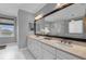 Spacious bathroom with dual sinks, a large mirror, and a walk-in shower with glass doors at 2806 Starwood Ct, Lakewood Ranch, FL 34211