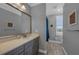 Charming bathroom featuring gray cabinets, neutral countertops, and decorative nautical-themed accents at 2806 Starwood Ct, Lakewood Ranch, FL 34211