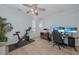 Bright bedroom featuring home office and fitness equipment, wood floors, and a ceiling fan at 2806 Starwood Ct, Lakewood Ranch, FL 34211