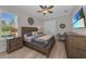 Comfortable bedroom featuring hardwood floors, plantation shutters and a ceiling fan at 2806 Starwood Ct, Lakewood Ranch, FL 34211