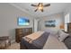 Comfortable bedroom featuring hardwood floors, plantation shutters and a ceiling fan at 2806 Starwood Ct, Lakewood Ranch, FL 34211