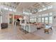 Open-concept clubhouse interior with stylish seating, large windows, and a kitchenette with modern appliances at 2806 Starwood Ct, Lakewood Ranch, FL 34211