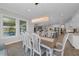 Bright, open dining room adjacent to kitchen and Gathering room featuring an oversized dining table and large windows at 2806 Starwood Ct, Lakewood Ranch, FL 34211