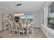 Elegant dining area with views of the backyard, a large window, and a modern light fixture at 2806 Starwood Ct, Lakewood Ranch, FL 34211
