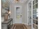 Elegant entryway featuring decorative glass door, stylish console table, and glass french doors at 2806 Starwood Ct, Lakewood Ranch, FL 34211