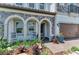 Charming stone accented front porch with rocking chairs and beautifully landscaped garden at 2806 Starwood Ct, Lakewood Ranch, FL 34211