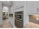 Gourmet kitchen featuring stainless steel appliances, granite countertops, and custom cabinetry at 2806 Starwood Ct, Lakewood Ranch, FL 34211