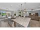 The open-concept kitchen features an eat-in island and seamlessly connects to the dining and living spaces at 2806 Starwood Ct, Lakewood Ranch, FL 34211